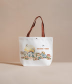 Tote bag with dinosaur illustration and 'Jurassic Times' text on a beige background