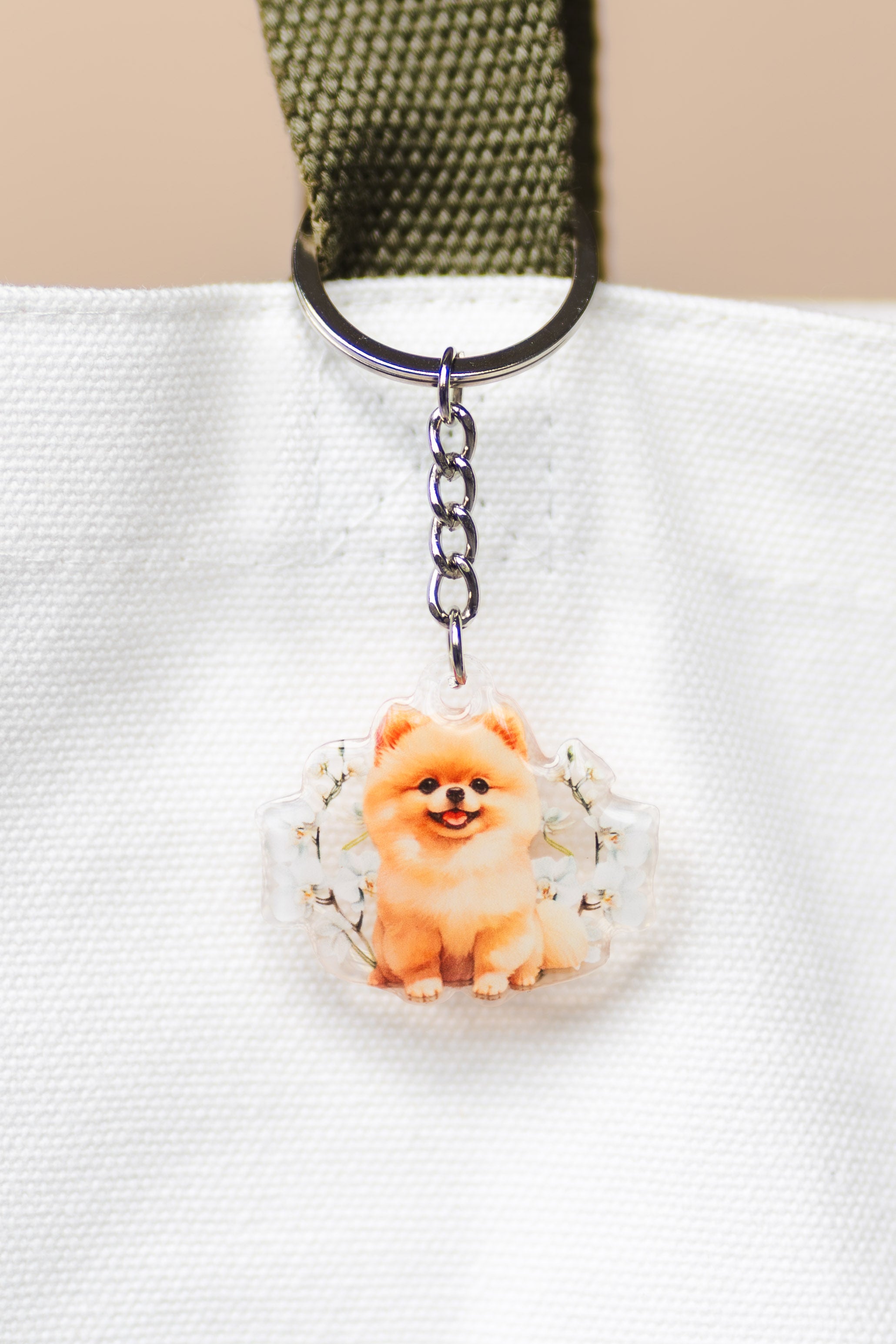 Pomenarian Dog Acrylic Keychain | Epoxy Coated on a white surface
