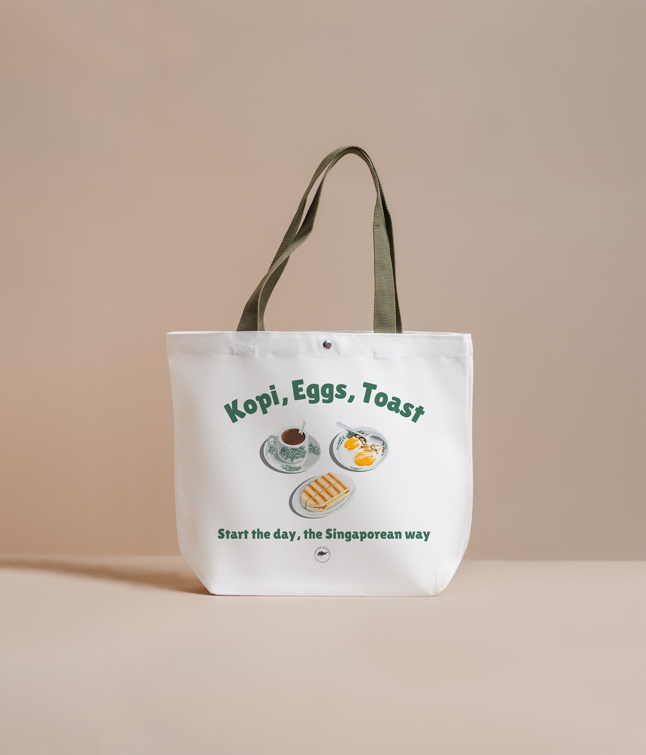 Tote bag with 'Kopi, Eggs, Toast' design on a beige background