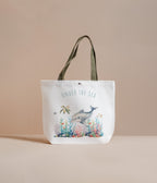 Tote bag with 'Under the Sea' design featuring a dolphin and coral on a beige background