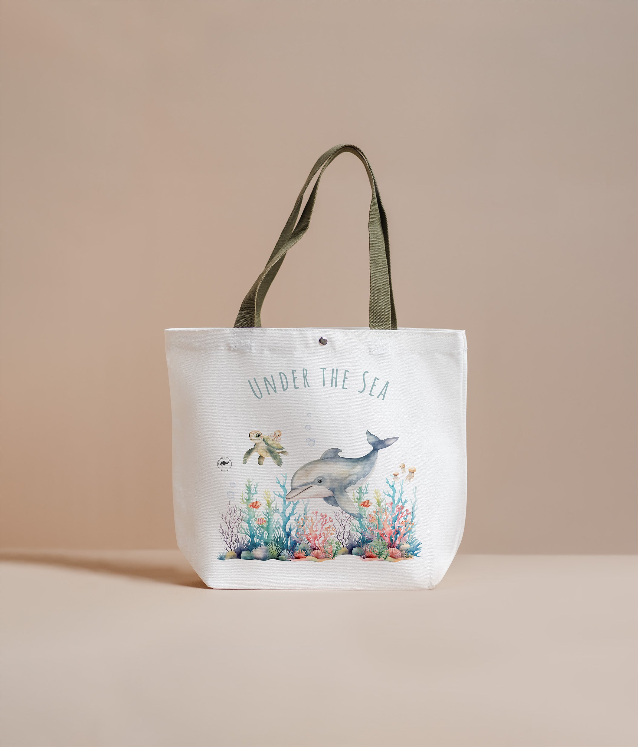 Tote bag with 'Under the Sea' design featuring a dolphin and coral on a beige background